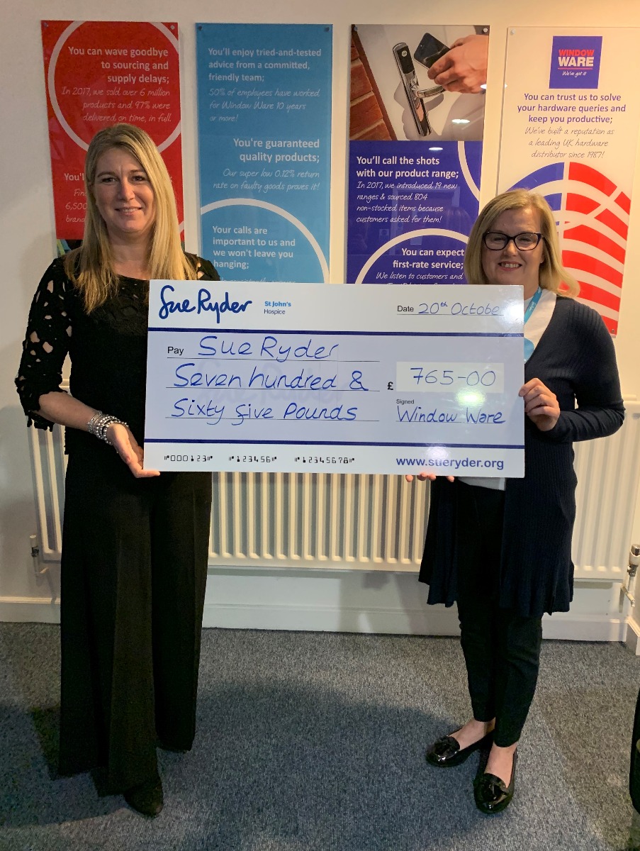 Sam Nuckey presents cheque for £765 to Sue Ryder